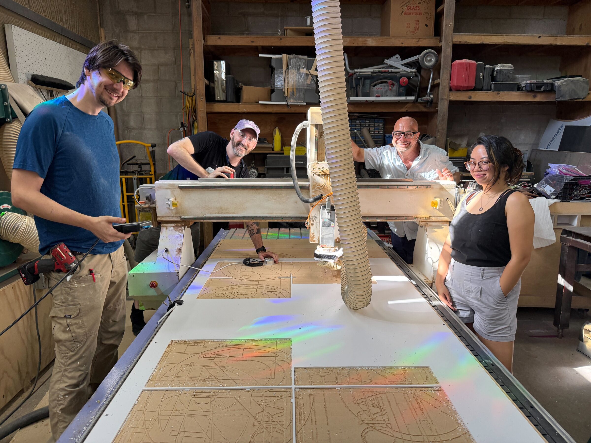 Wizard Studios fabricators running a CNC router in the shop